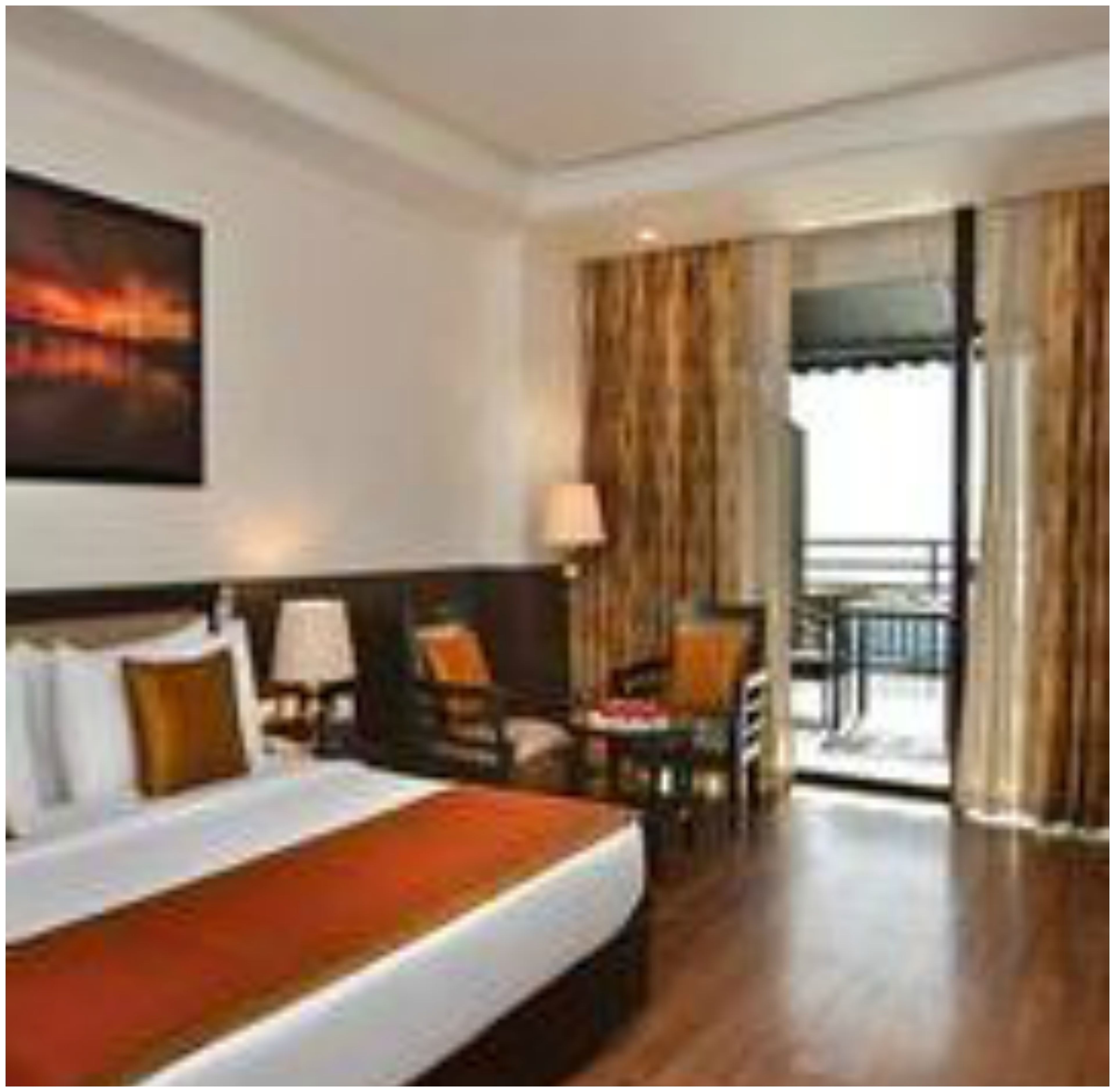 deluxe room | minibar, in-room safe, desk, iron/ironing board