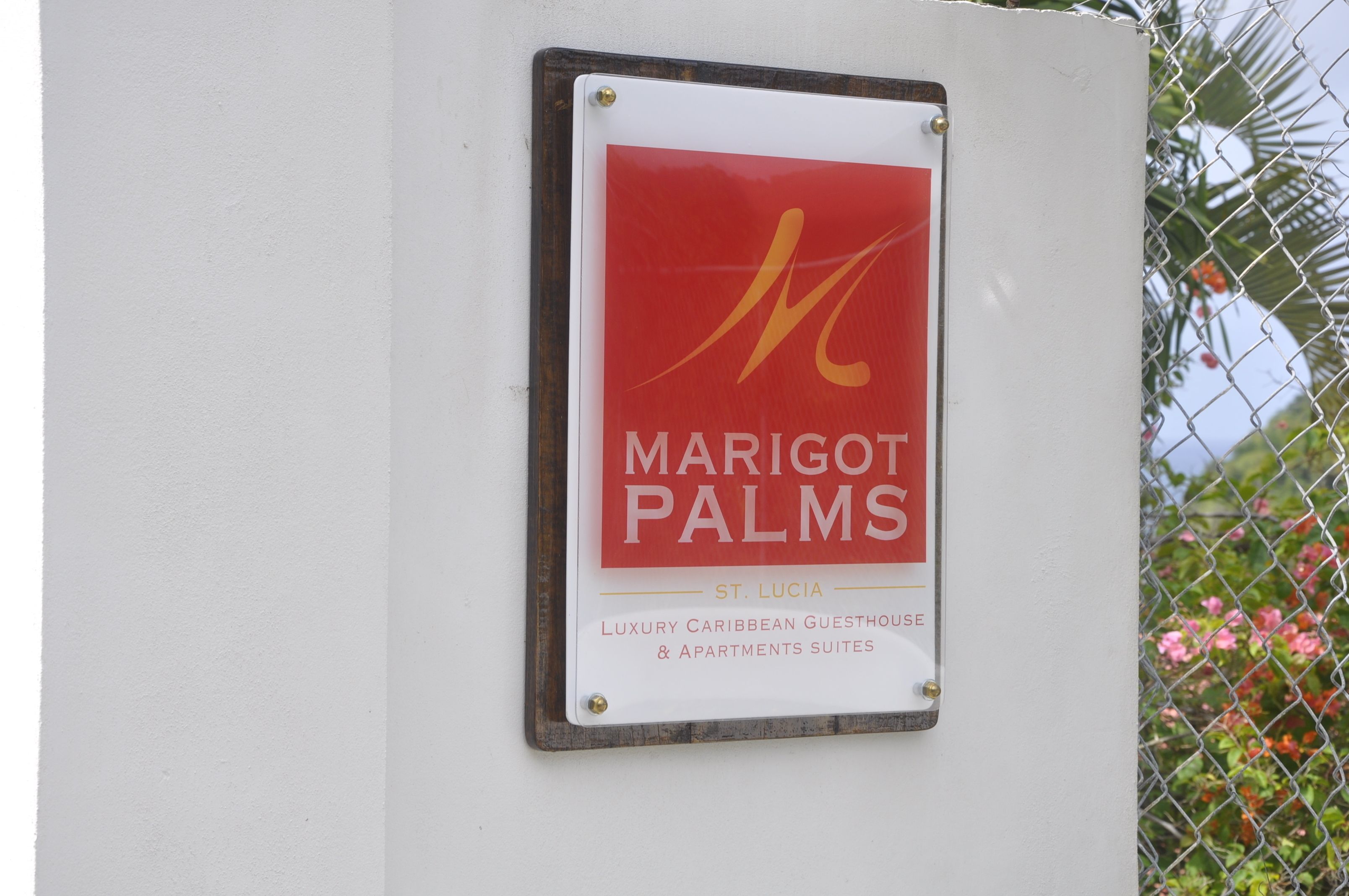 A sign for Marigot Palms, a luxury Caribbean guesthouse and apartments suites in St. Lucia.