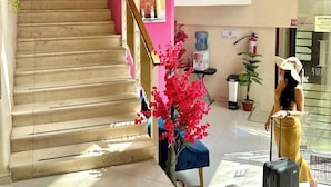 A hotel lobby with a staircase, a water dispenser, a fire extinguisher, and a plant. - Hotel Barranquilla (Campeche)