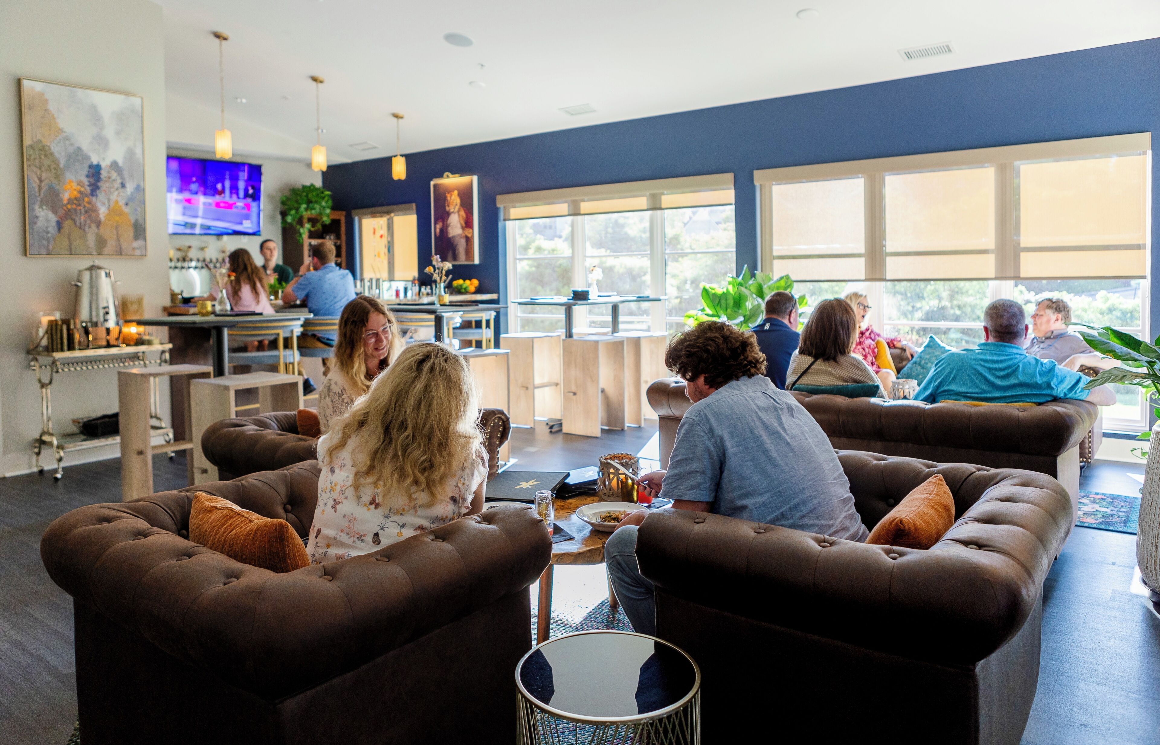 A modern lounge area with sofas and a coffee bar.