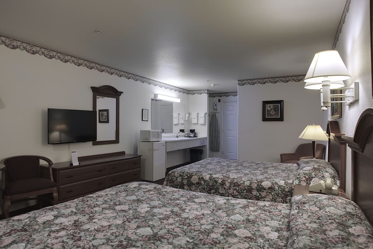 standard room, 2 queen beds, refrigerator & microwave | 2 bedrooms, iron/ironing board, free wifi, bed sheets