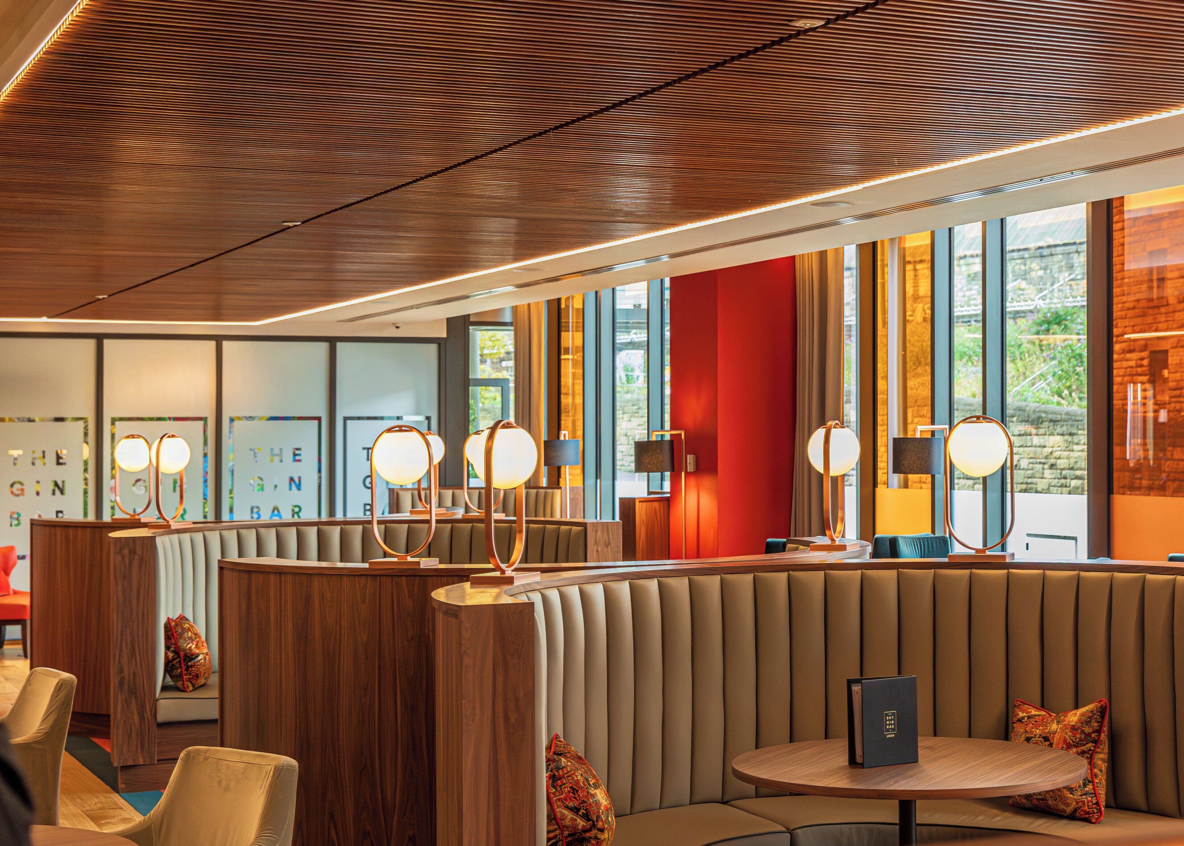 A modern bar area with seating and ambient lighting.