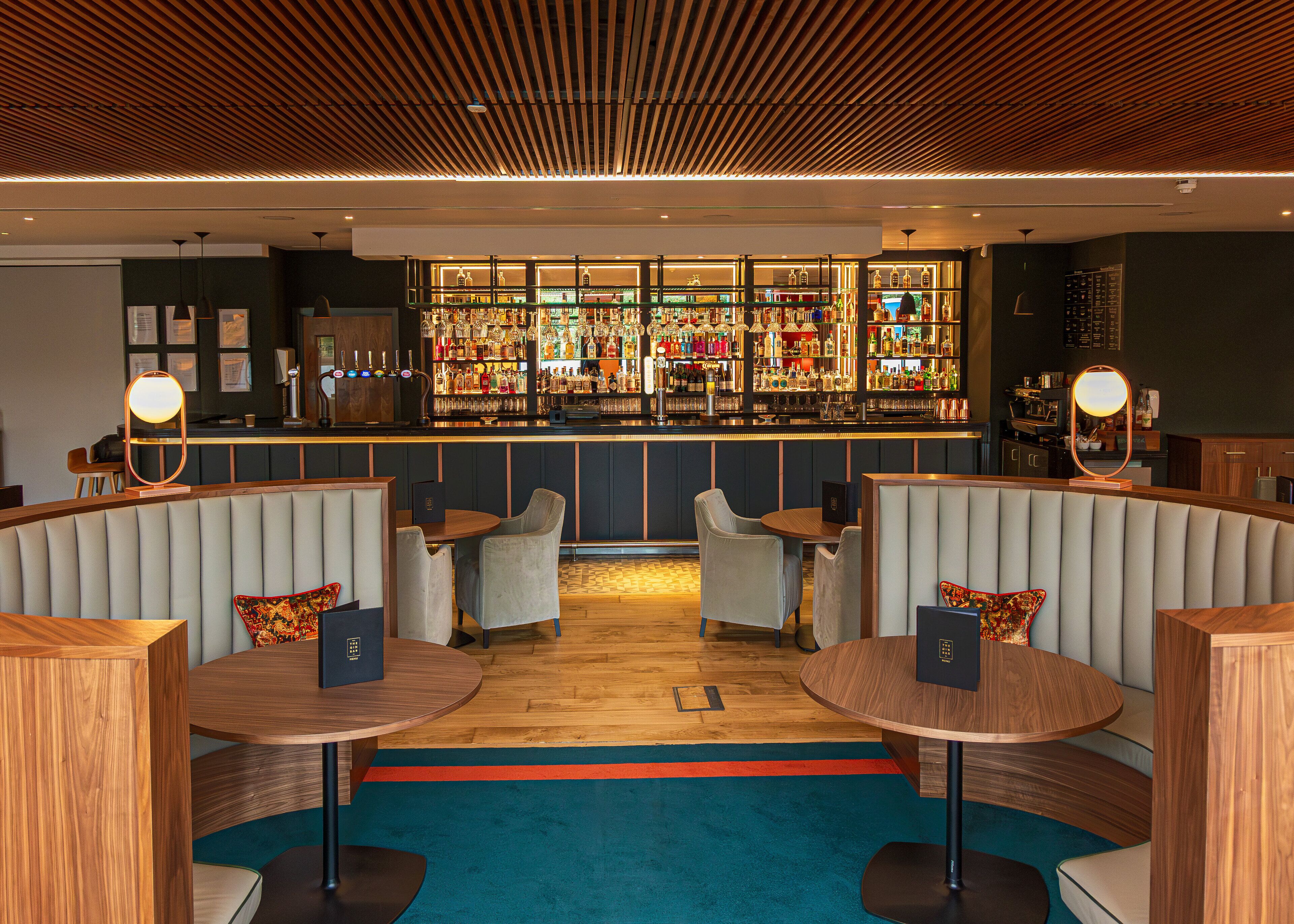 A bar area with seating and a well-stocked liquor display.