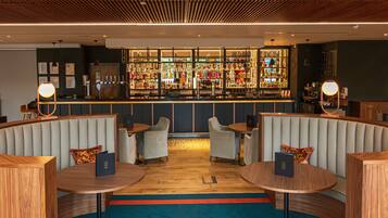 A bar area with seating and a well-stocked liquor display.