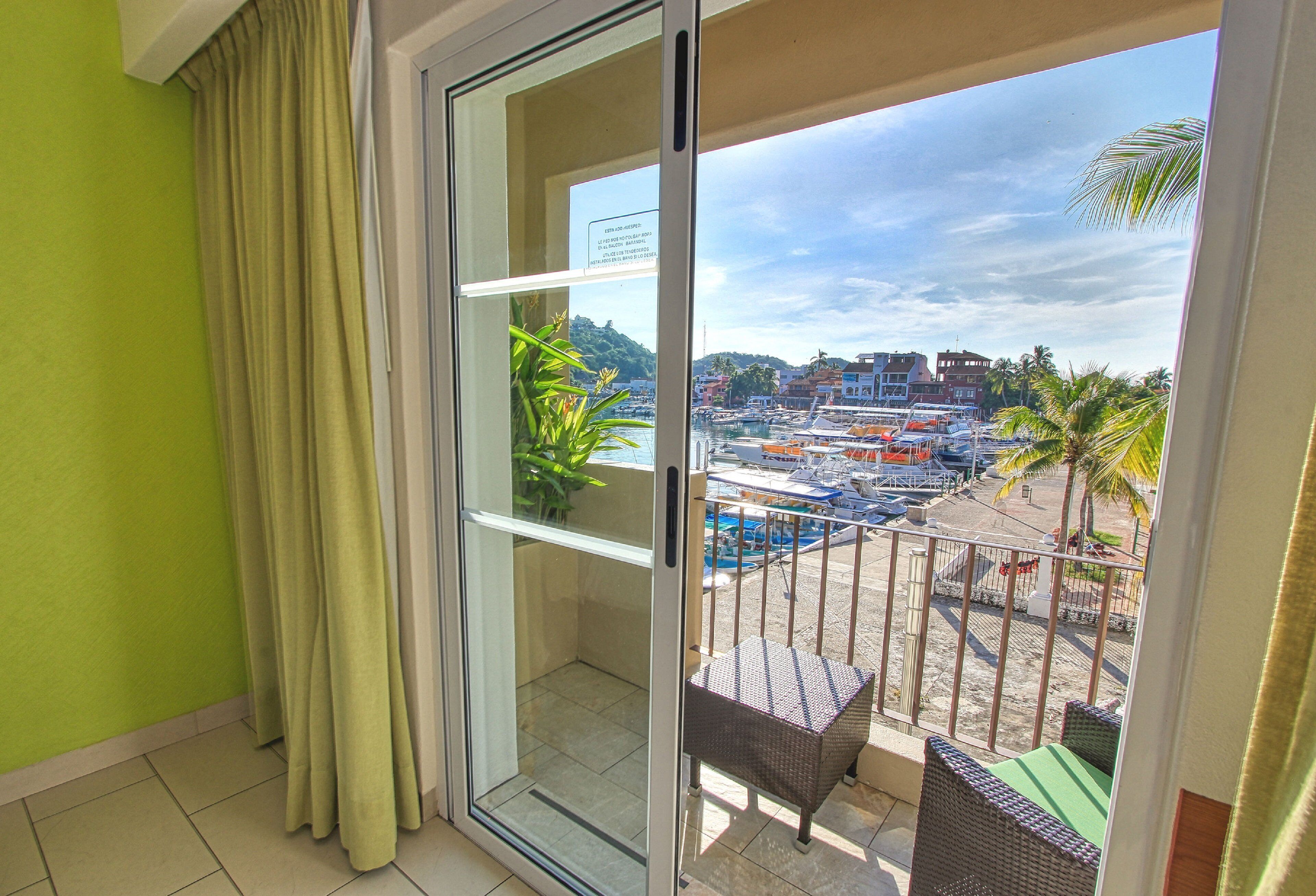 A balcony with a view of a marina and buildings.