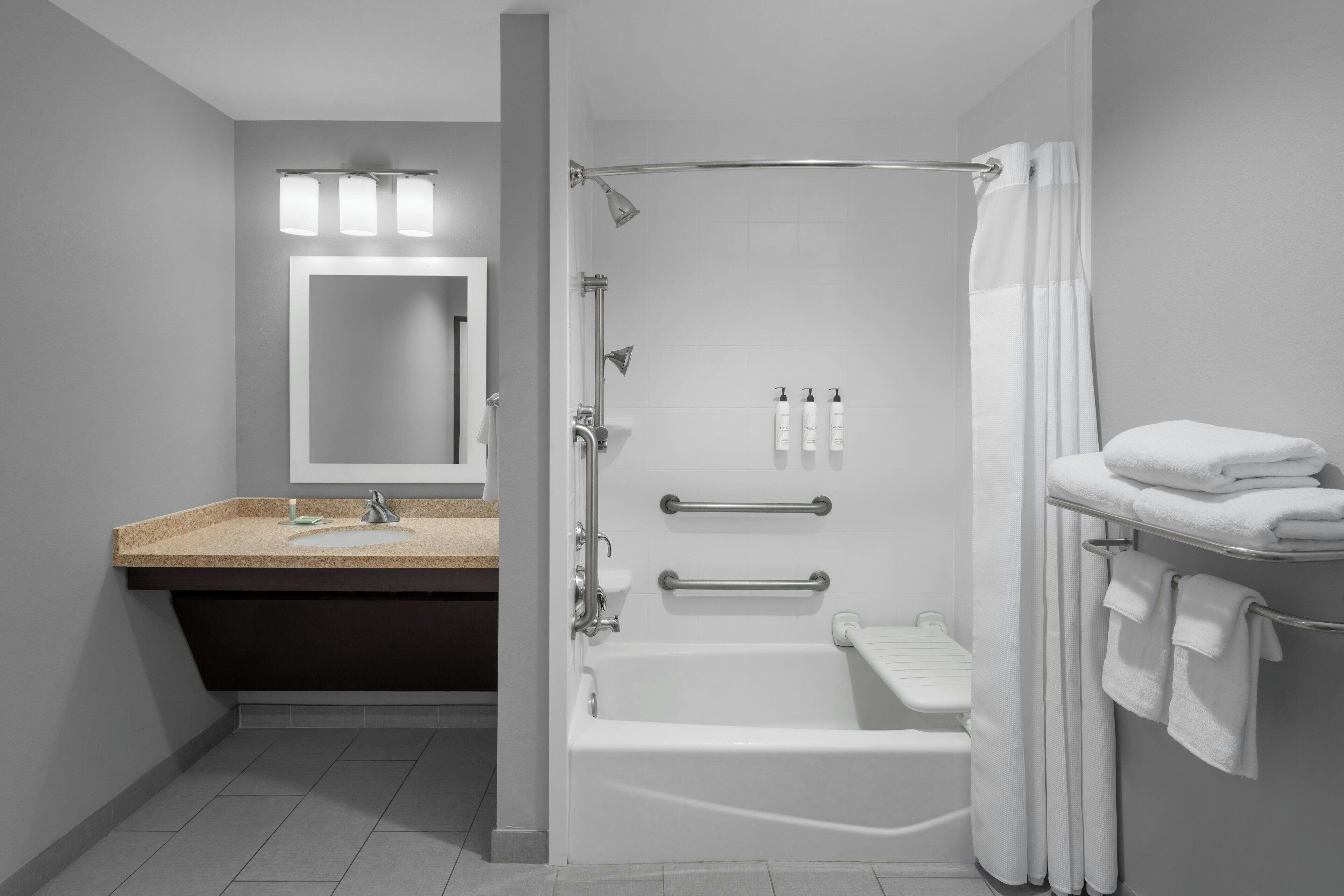 studio, 1 king bed with sofa bed, non smoking (mobility accessible, tub) | bathroom | combined shower/bathtub, rainfall showerhead, designer toiletries