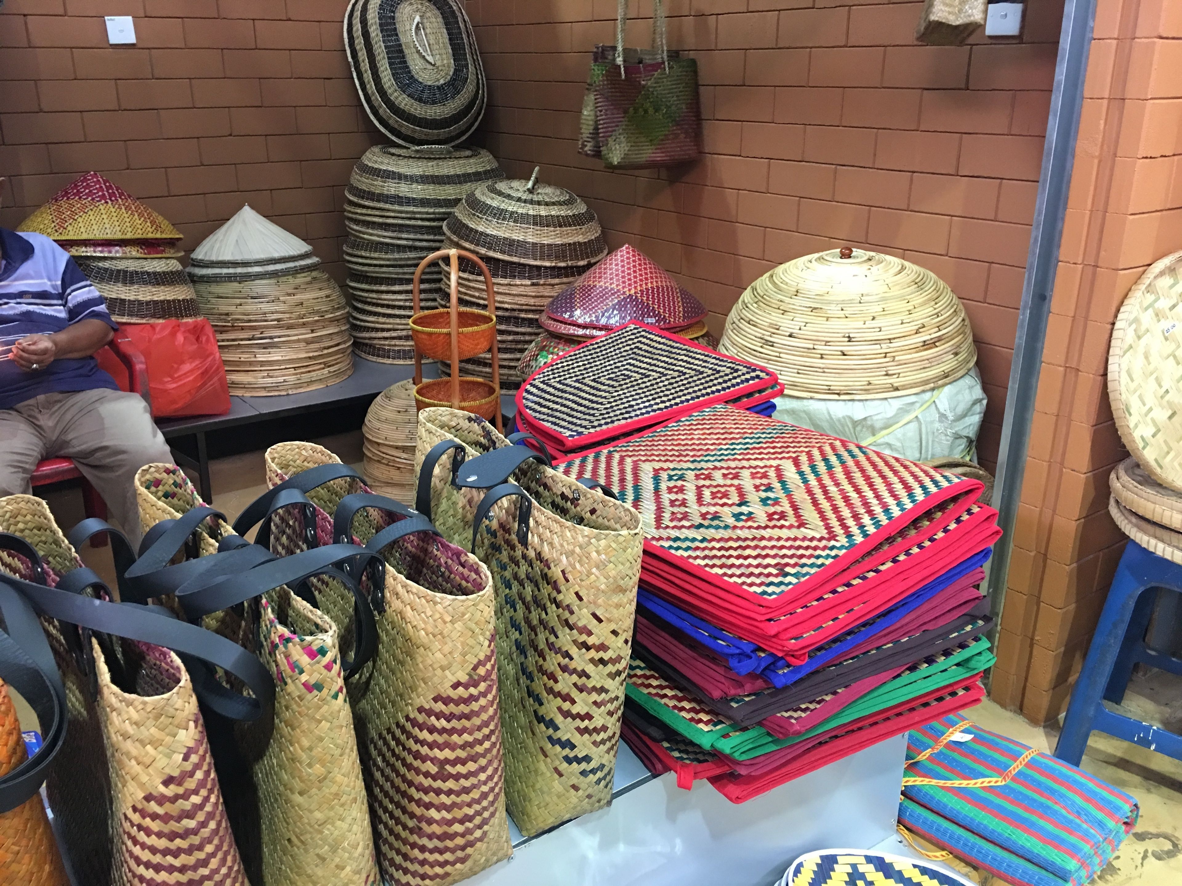 A display of woven baskets and bags in various sizes and colors.
