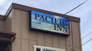 Un edificio con un letrero que dice "PACIFIC INN".