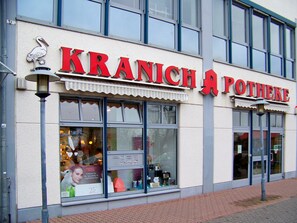A storefront with the name "KRANICH A POTHEKE" in large red letters. - Hotel Amadeus ROYAL Berlin (Hoppegarten)