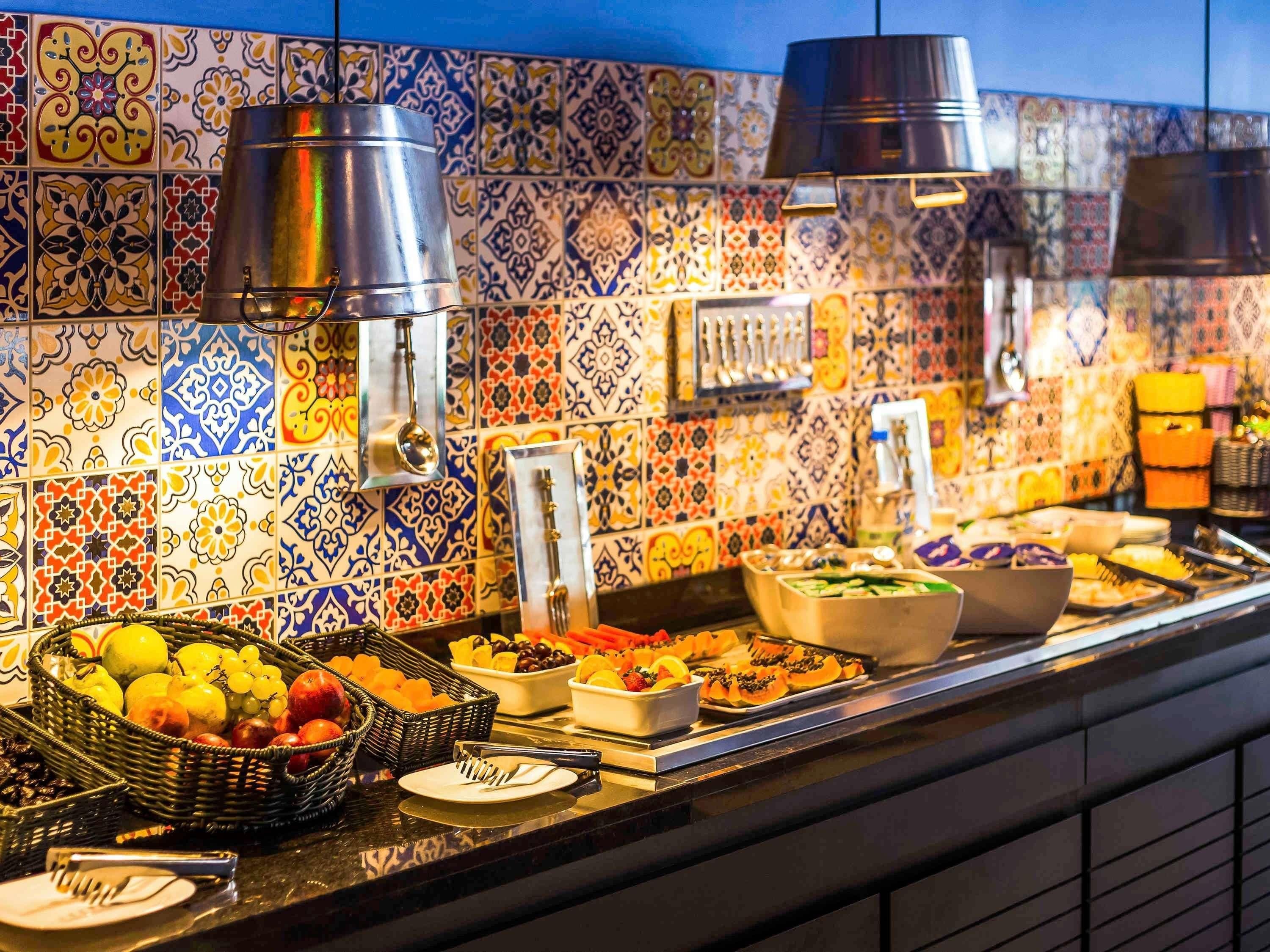 A buffet with various food items and utensils.