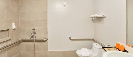 A bathroom with a shower, toilet, and sink.
