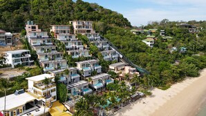 A modern resort with multiple buildings, a pool area, and a beach. - Bandara Pool Villas, Phuket (Wichit)