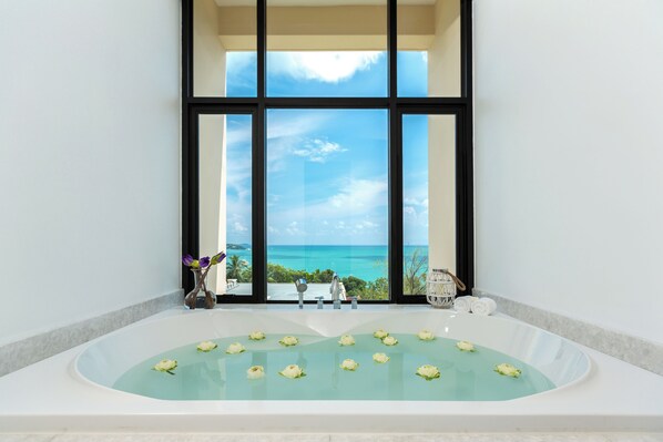 A large bathtub with a view of the ocean through large windows. - Bandara Pool Villas, Phuket (Wichit)