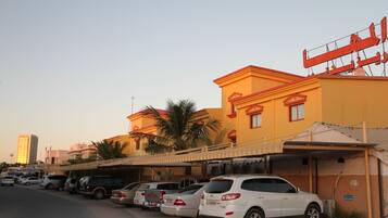 Guests can park their vehicles in the designated lot adjacent to the building.