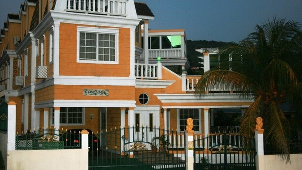 A multi-story building with a prominent balcony and a sign that reads "Fairview." - Fairview Guest House (Kingstown)