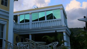A two-story building with large windows and a balcony. - Fairview Guest House (Kingstown)
