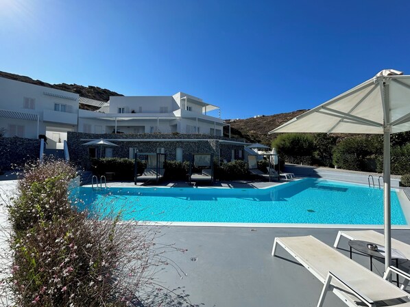 Outdoor pool, open 10:00 AM to 8:00 PM, pool umbrellas, pool loungers