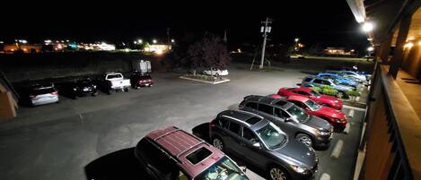 A parking lot with various cars and a white truck.
