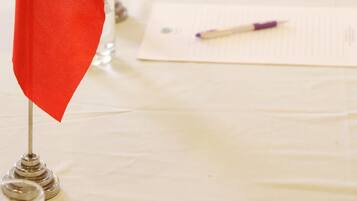 A table with flags, documents, and a pen.