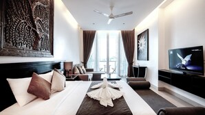 A hotel room with a large bed, a flat-screen TV, a ceiling fan, and a large window with curtains. - Crystal Blue Boutique Hotel (Phnom Penh)