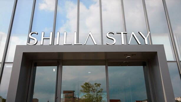 The exterior of a building with the sign "SHILLA STAY" indicating a hotel or accommodation.