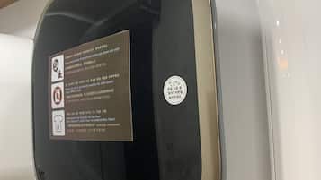 A white washing machine with a black door, labeled with the number 163 and 12.