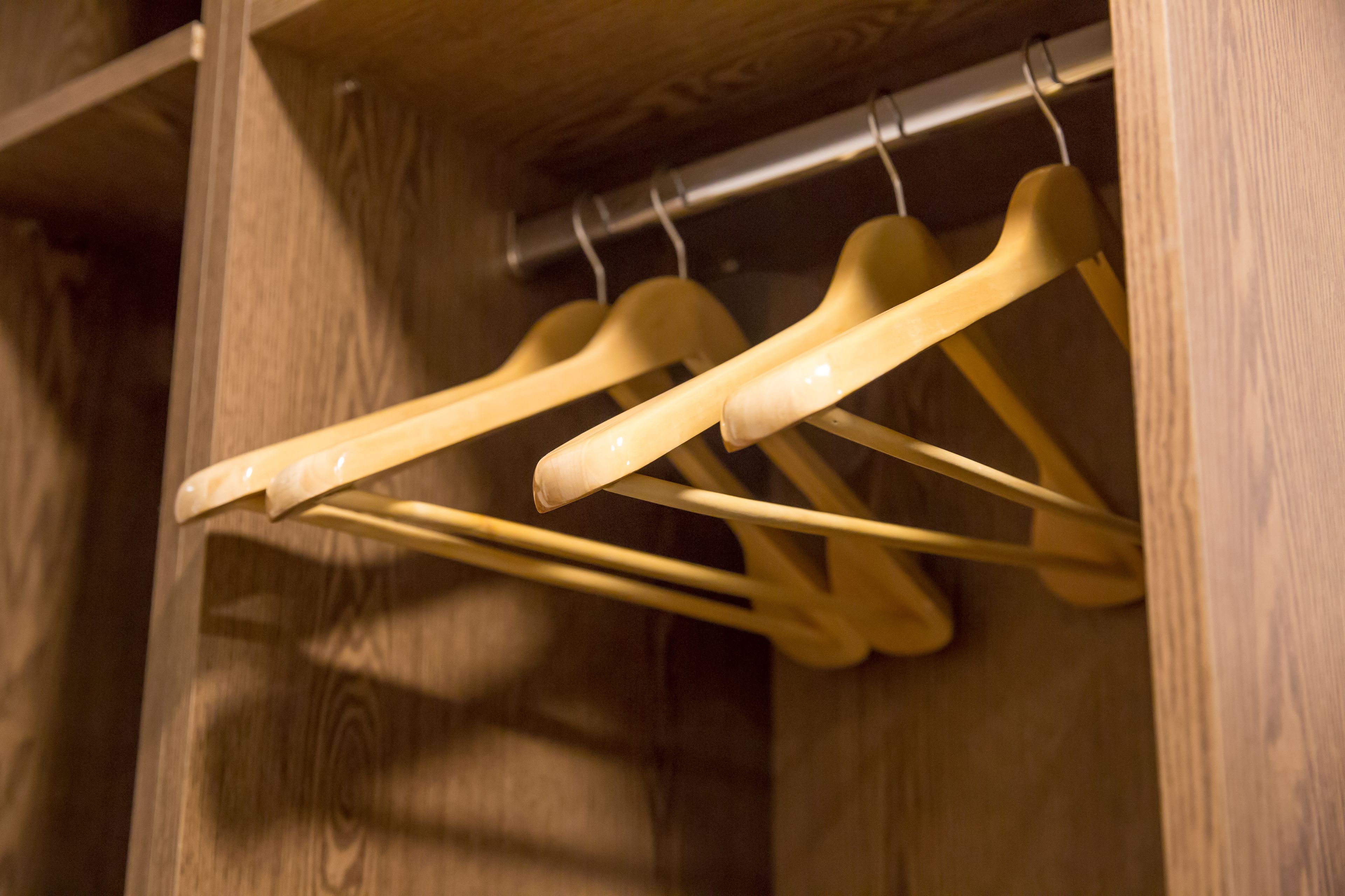 Wooden hangers in a closet.