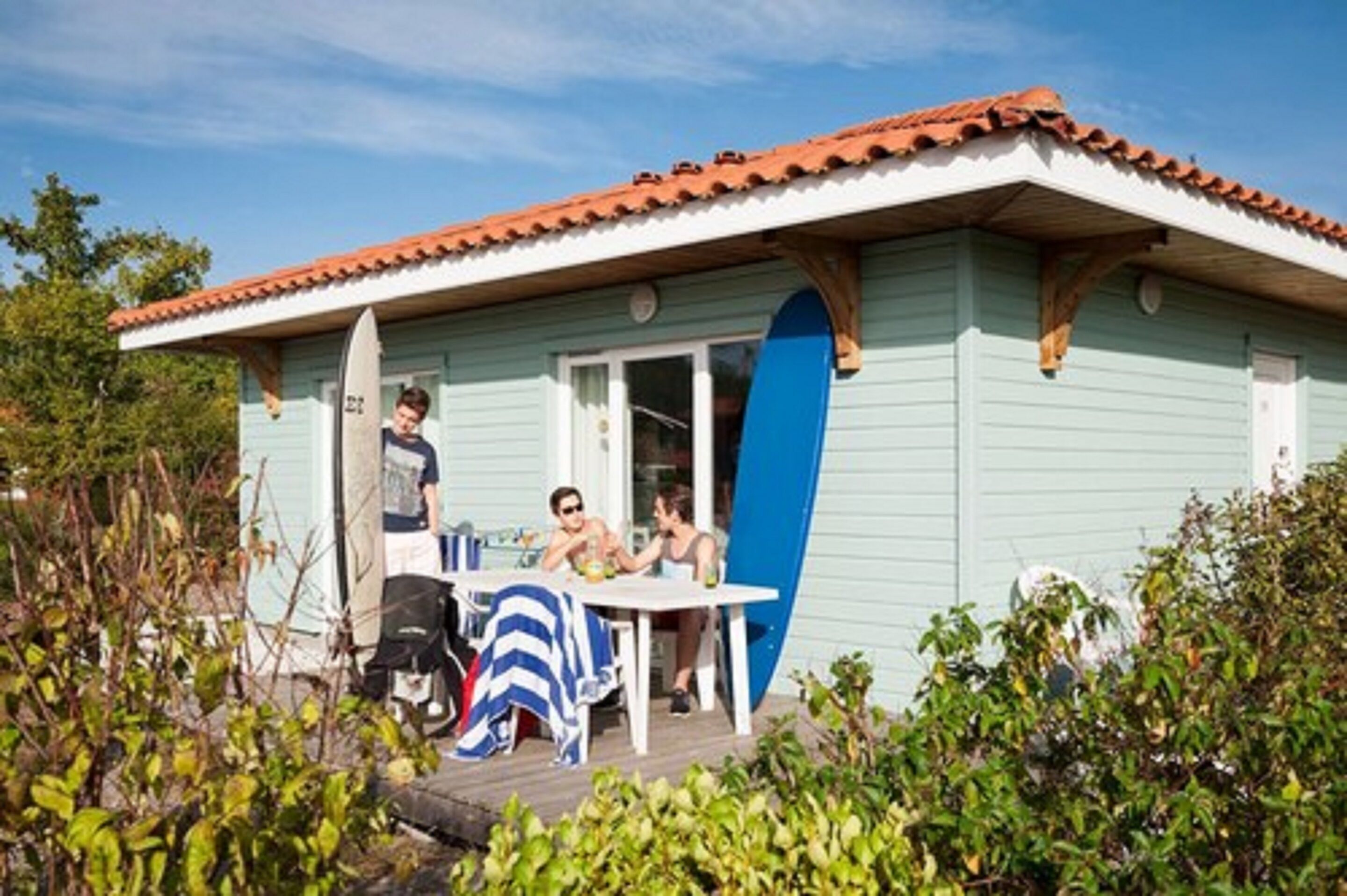 A small house with a tiled roof and a covered porch.