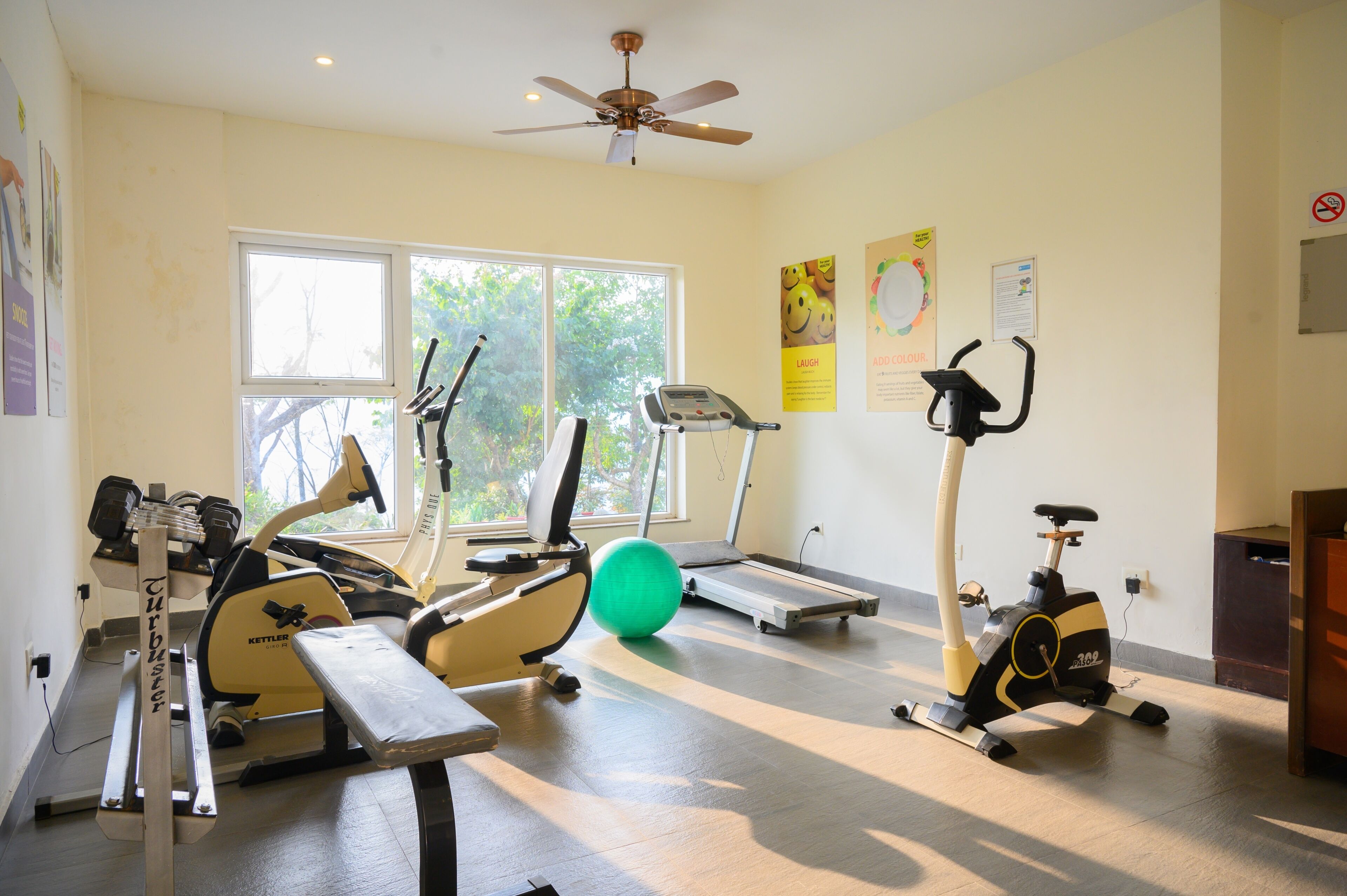A gym with various exercise equipment including treadmills, an elliptical, and a stationary bike.