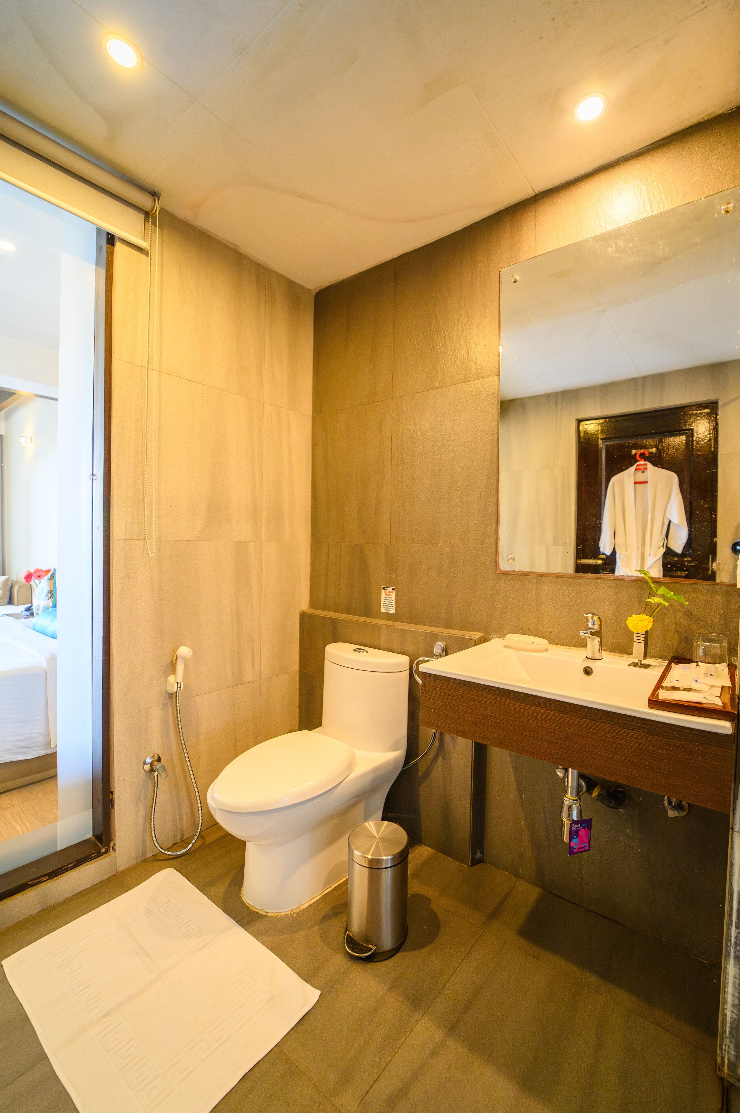 A modern bathroom with a toilet, sink, and mirror.