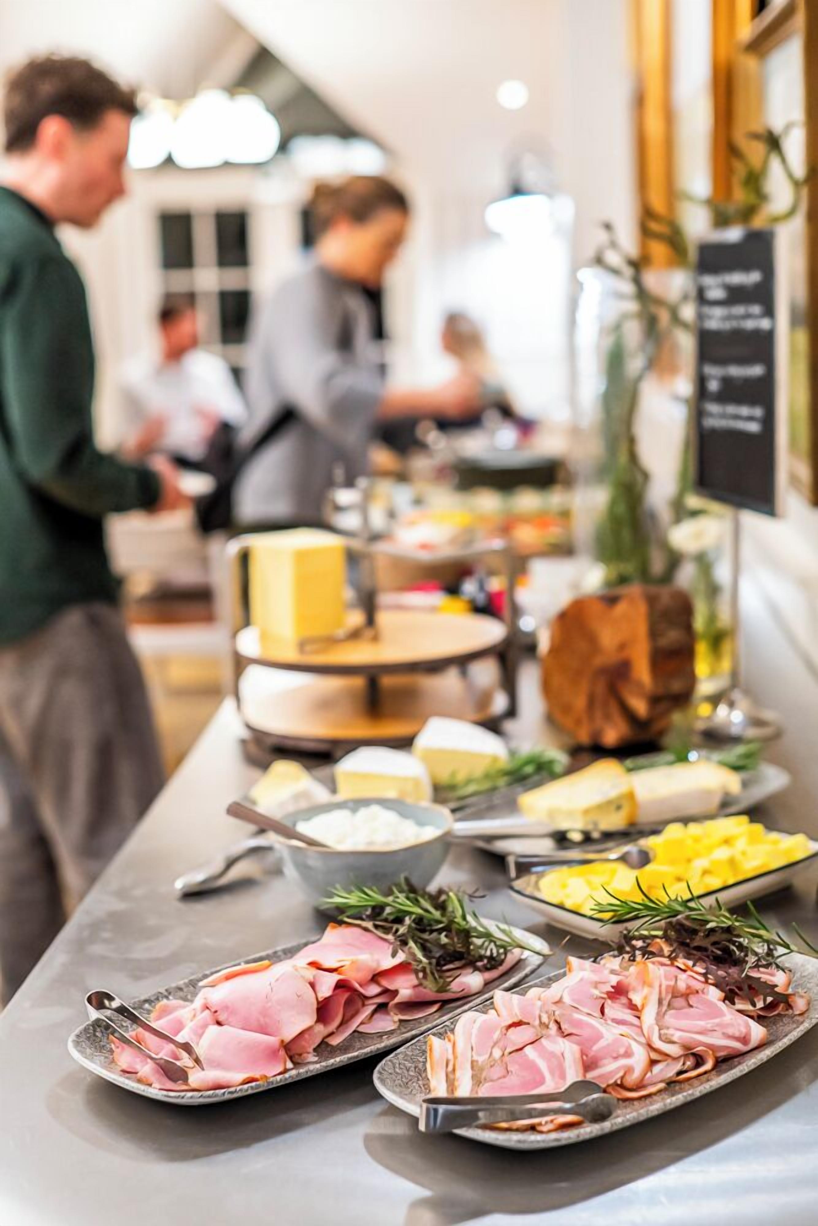 A buffet setup with various food items and a signboard.