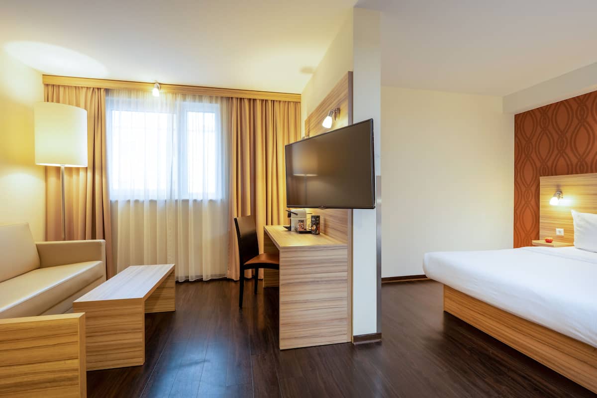 Family Quadruple Room | Minibar, in-room safe, desk, laptop workspace