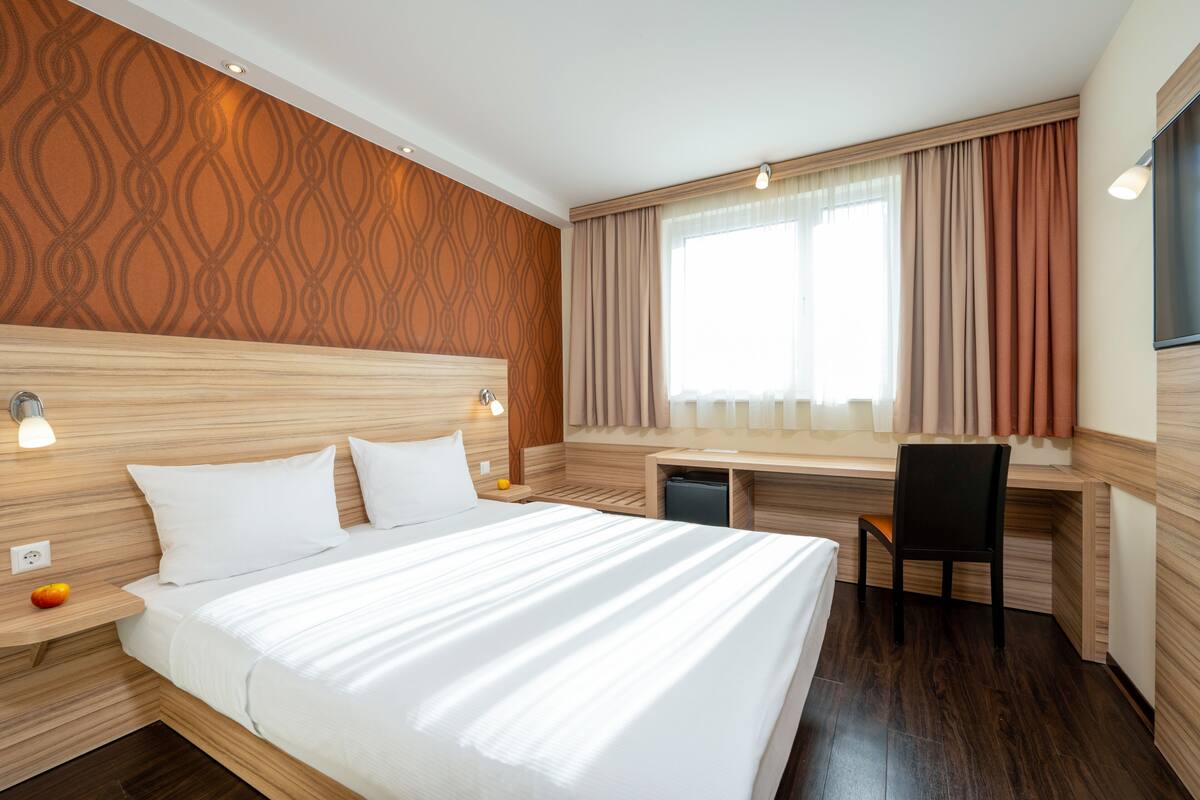 Classic Double Room | Minibar, in-room safe, desk, laptop workspace