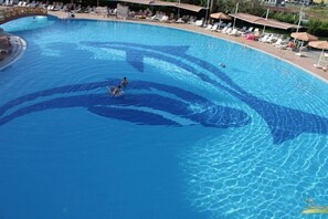 A swimming pool with a shark design, lounge chairs, and umbrellas. - Adalya Art Side - All Inclusive (Manavgat)