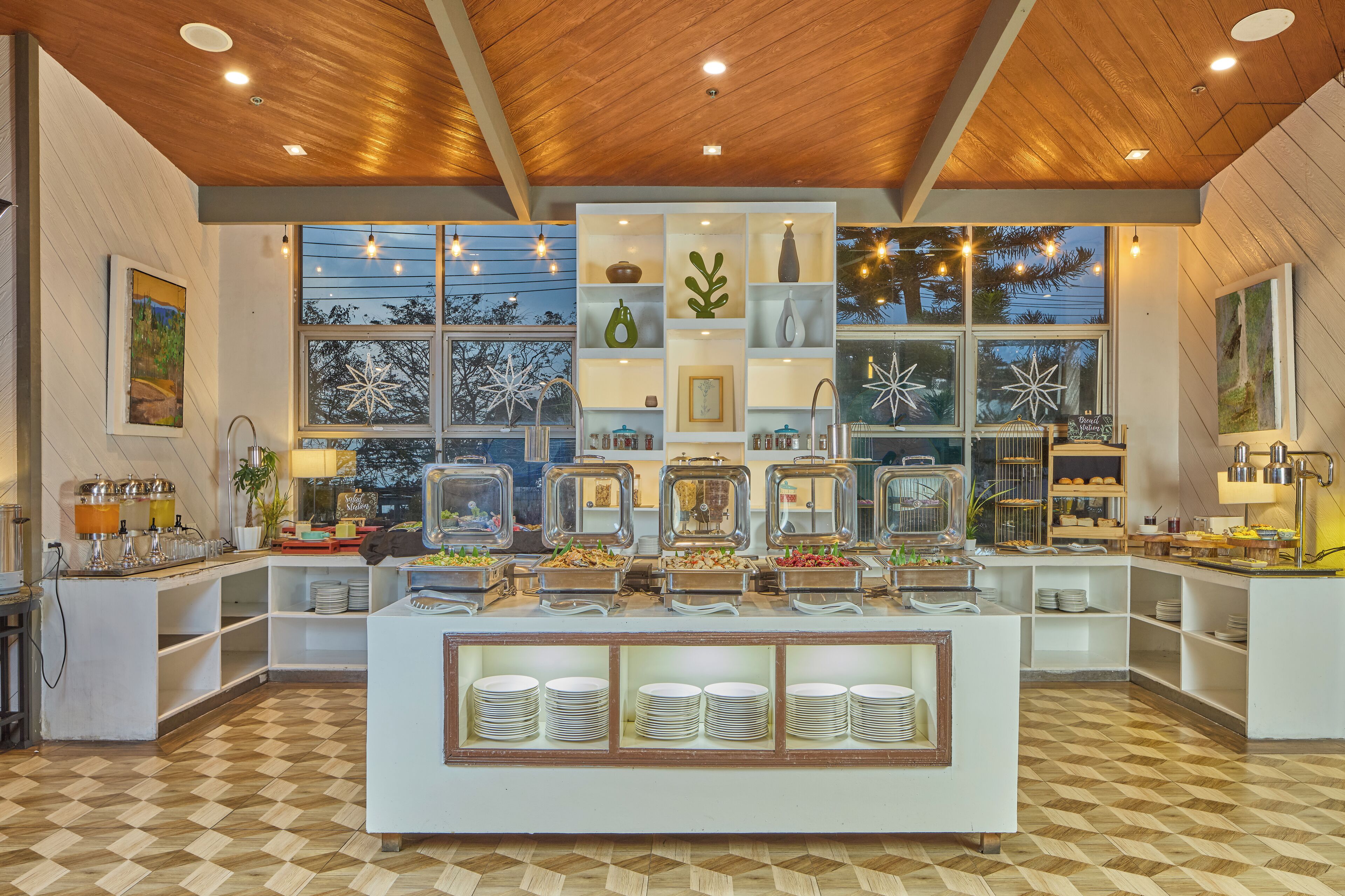 A buffet setup with multiple food stations, glass display cases, and a central serving area.
