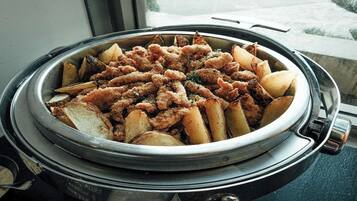 A buffet with fried chicken and potatoes.