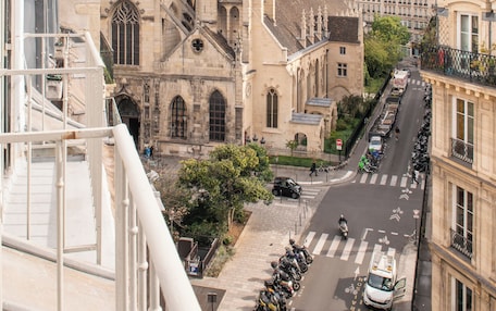 A street view with a prominent church and adjacent buildings.