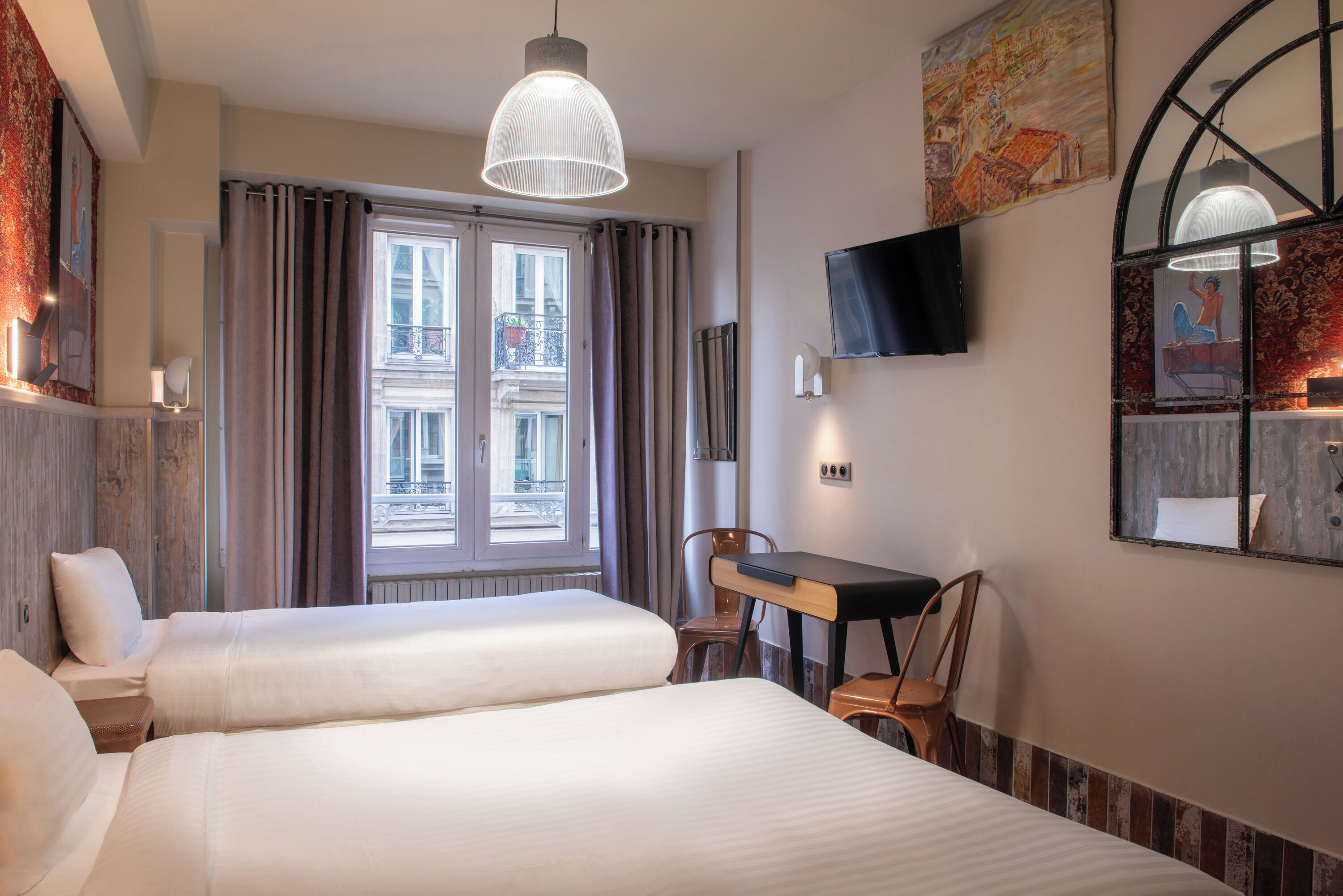 A hotel room with two beds, a desk, a chair, a TV, and a window with curtains.