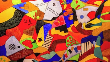 A colorful abstract painting with various shapes and patterns.