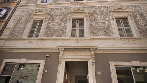 A historic building with ornate facade, large windows, and a prominent entrance.