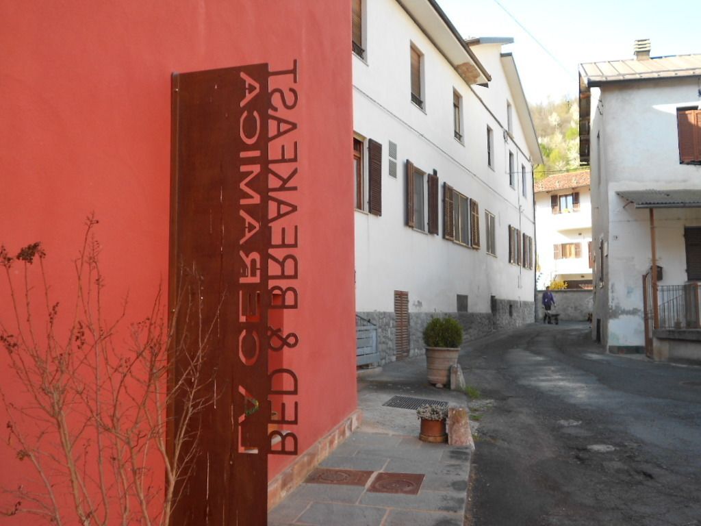 A narrow street with a building featuring a red door and a sign that reads "BED & BATHES."