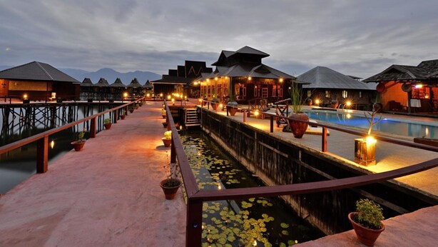 An overwater bungalows with a pool, wooden walkways, and potted plants. - Shwe Inn Tha Floating Resort Hotel (Nyaungshwe)