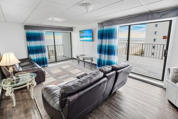 Oceanfront King Penthouse (no pets) | Living area | 50-inch flat-screen TV with cable channels, TV at Tropical Seas Hotel