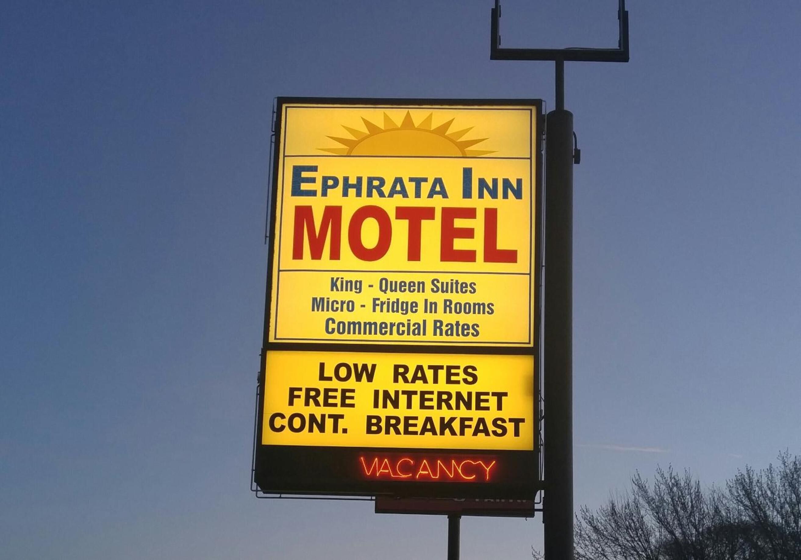 A motel sign with the name "Ephrata Inn Motel" and mentions "King - Queen Suites," "Micro - Fridge In Rooms," and "Commercial Rates." It also advertises "LOW RATES," "FREE INTERNET," and "CONT. BREAKFAST." The sign indicates a "VACANCY."