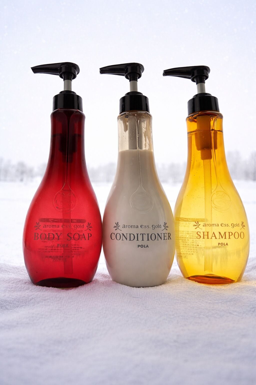 Three bottles of body soap, conditioner, and shampoo.
