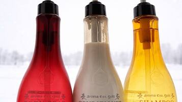 Three bottles of body soap, conditioner, and shampoo.