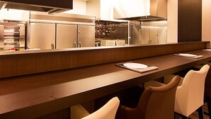 A long counter with a digital scale, a microwave, and a stove in the background. - Iwamizawa Hotel 5 Jo (Iwamizawa)