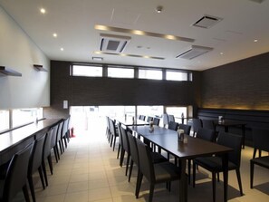 A conference room with a long table and chairs, large windows, and a modern ceiling design. - Iwamizawa Hotel 5 Jo (Iwamizawa)