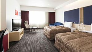 A hotel room with two beds, a desk with a chair, a television, and a window with curtains. - Hotel North City (Sapporo)