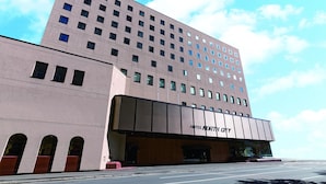 A modern hotel building with a flat facade, multiple windows, and a prominent entrance. - Hotel North City (Sapporo)